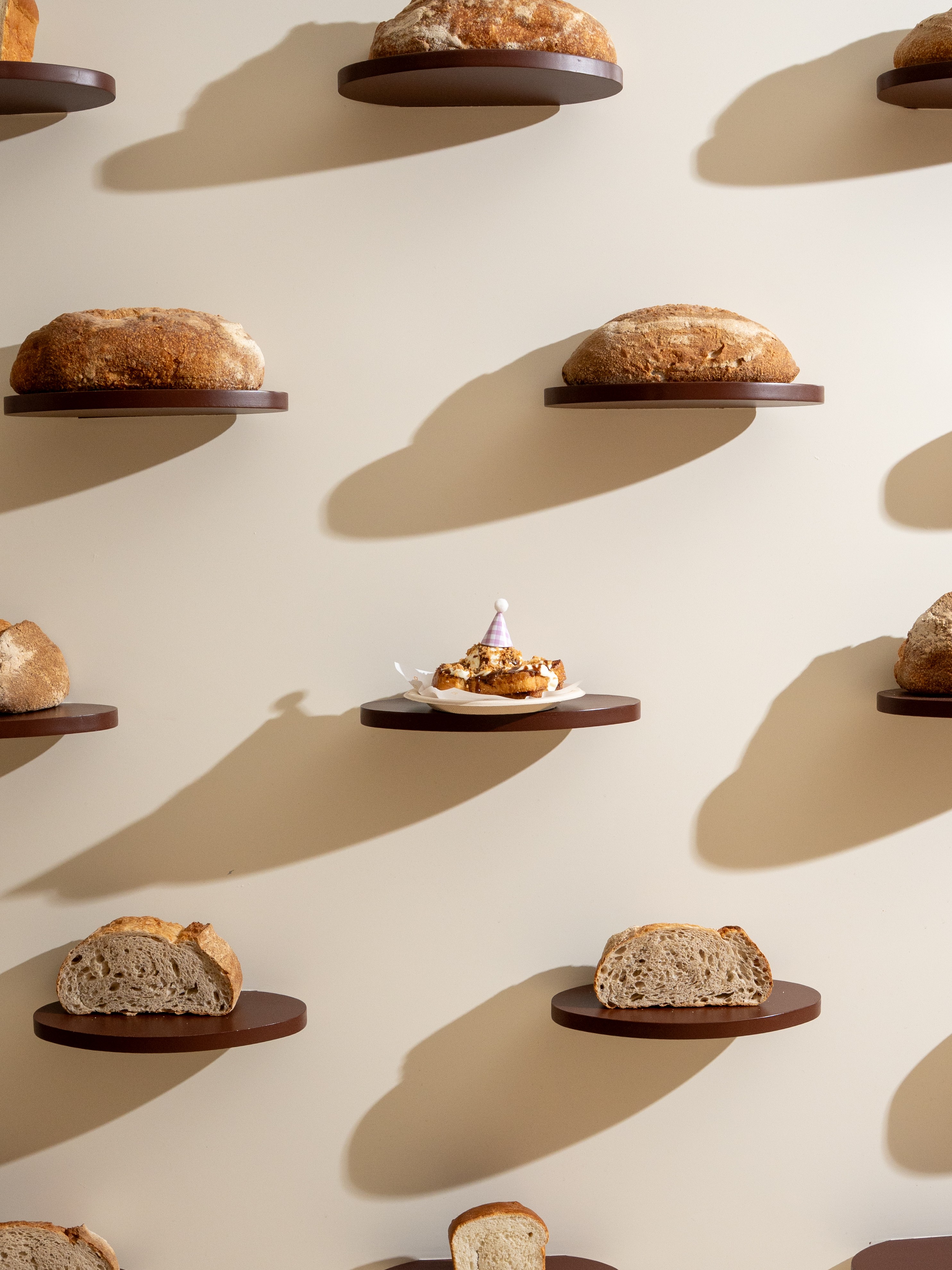 Birthday french toast on a wall of bread shelves